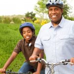 This is a photo of a father and son riding bikes.