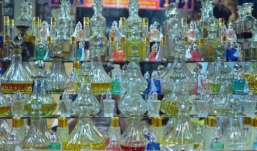 fragrance This is an image of many vintage glass perfume bottles. The bottles contain a variety of brightly colored fragrances.