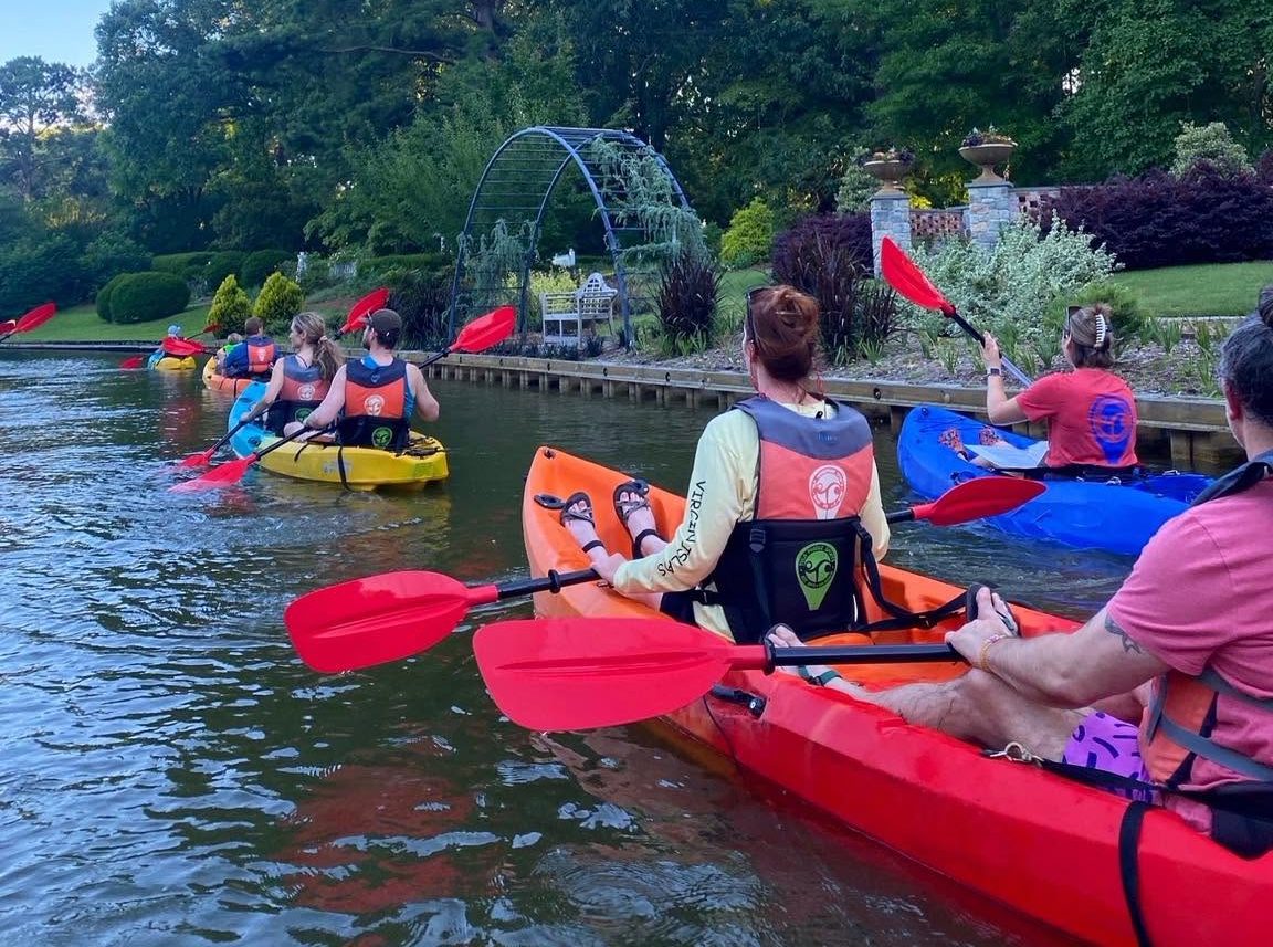 Group of people kayaking on canal