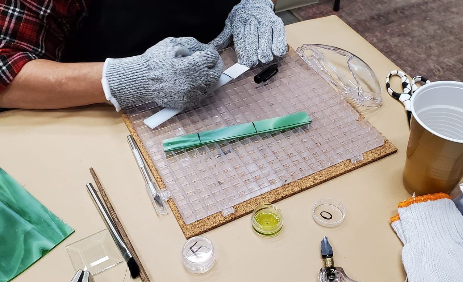 person measuring glass for cutting