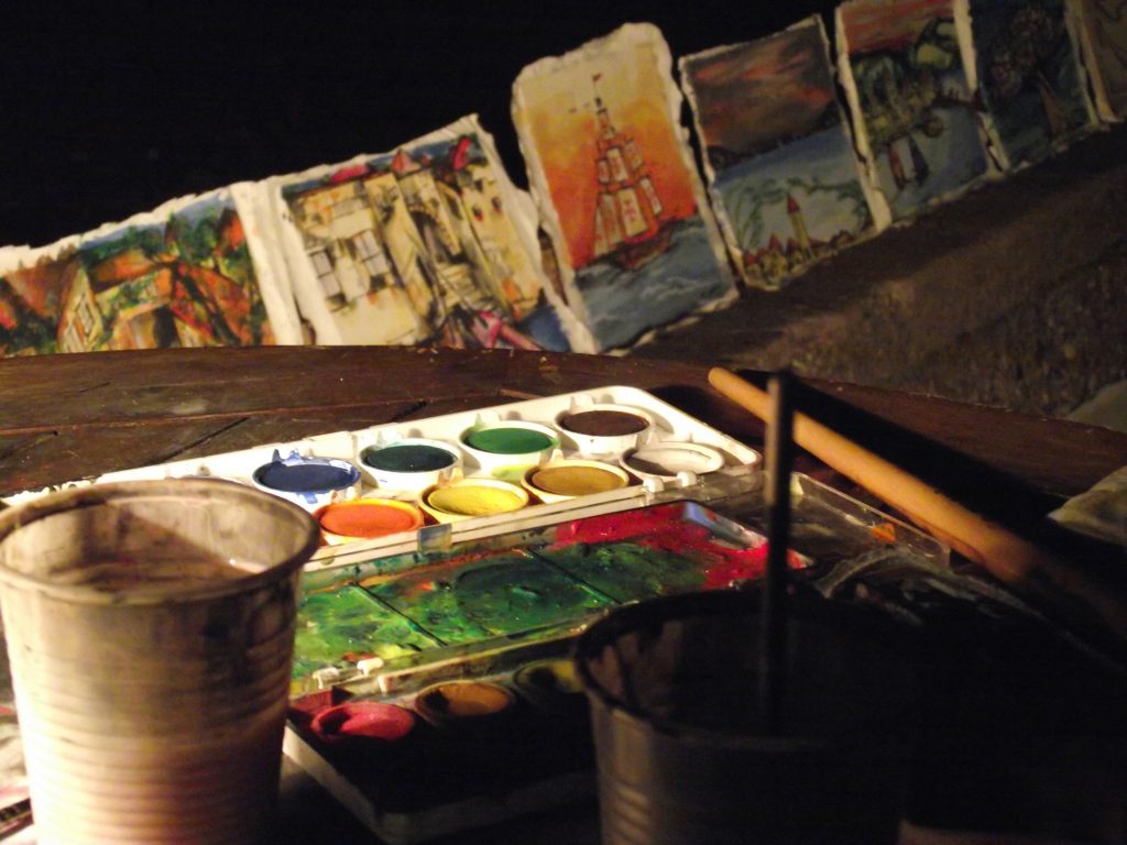 pallet of watercolors and background of paintings